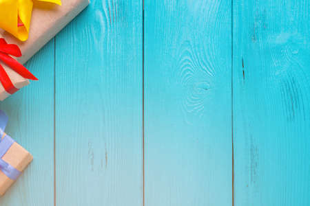 Turquoise background for Christmas cards. Blue wooden planks. Vintage background for congratulation. Christmas gifts. Holiday gift. Lighting a bright flash. A ray of light on a blue backgroundの写真素材