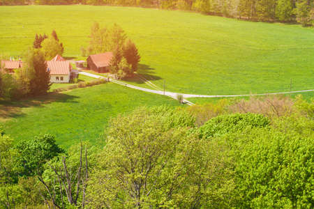 View from the drone on a country house with buildings. Summer nature near the German village. View from the height of the green forests, fields, meadows.の写真素材