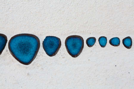 Blue pattern of glaze applied to a light gray background. Blue paint drops on white surface...