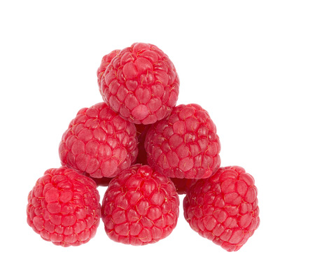 The raspberry berries put in the form of a triangle on a white background