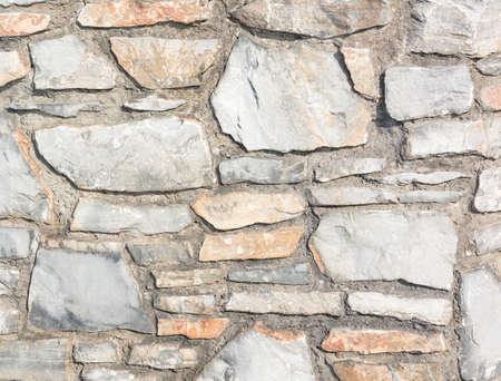 Background with masonry of stones of irregular shape in gray