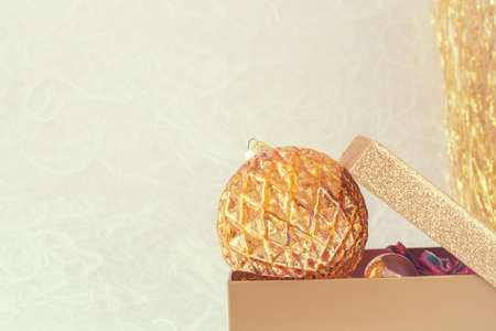 Background with Christmas golden Christmas ball in a boxの写真素材