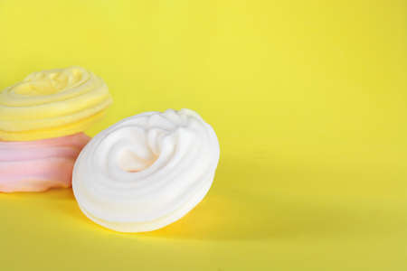 White meringue with shadow on yellow backgroundの写真素材