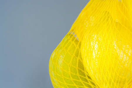Gray background with lemons with copy space