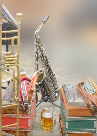 Musical instruments accordions and saxophone in daylight, blurred backgroundの写真素材