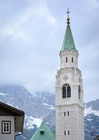 View of the church clock tower in the Dolomitesの写真素材