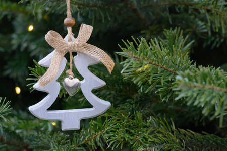 Dark green background blurred with wooden decoration in the form of a Christmas tree