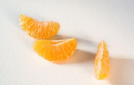 Mandarin slices on a light background