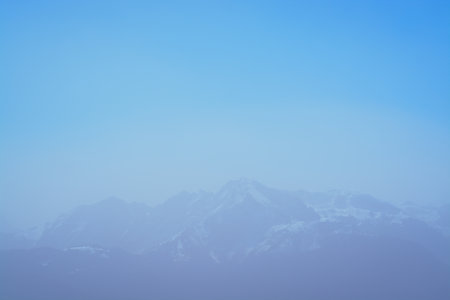 Background with blue sky and distant mountainsの写真素材