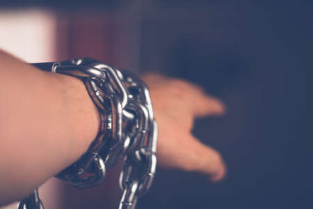 Metal chain in male hand with blurry backgroundの写真素材