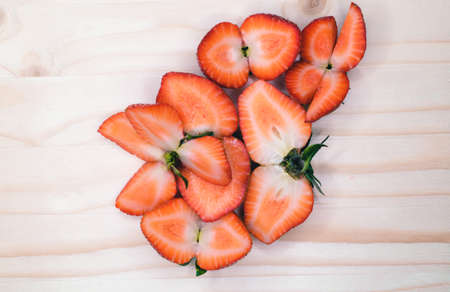 sliced strawberries on a wooden surfaceの写真素材