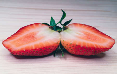 sliced strawberries on a wooden surfaceの写真素材
