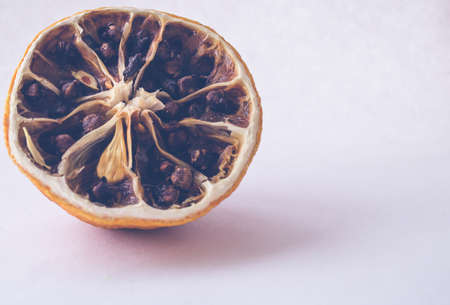 Dried lemon with cloves on a white backgroundの写真素材