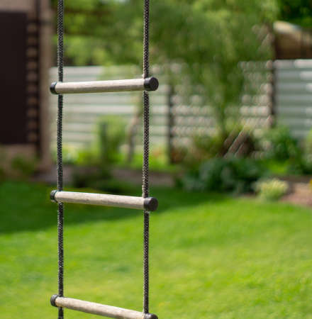 Rope ladder on a background of green lawn and plantsの写真素材