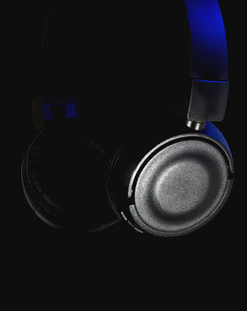 Black backlit headphones on a black backgroundの写真素材