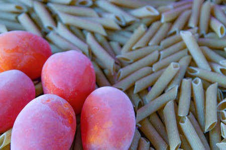 frozen tomatoes lie on pastaの写真素材
