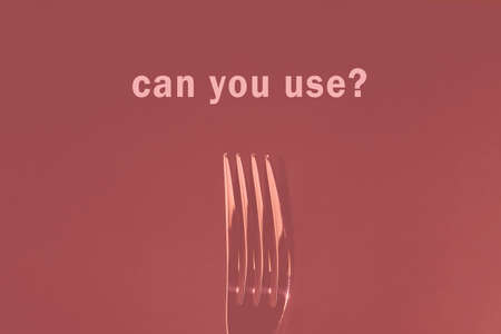 Dining fork on a colored background with the inscription
