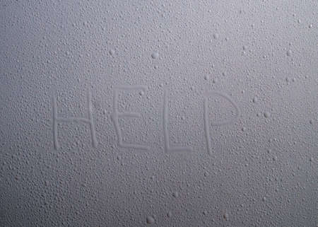 The inscription "help" a drop of water on the surfaceの写真素材