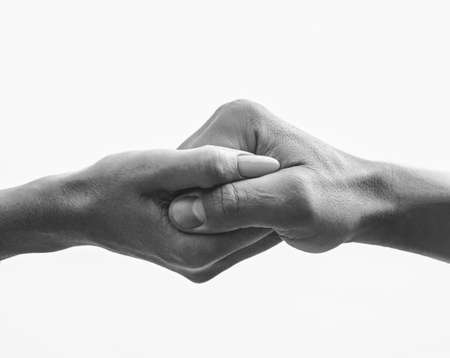 Female hand intertwined with a male handの写真素材