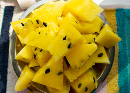 yellow watermelon in handの写真素材