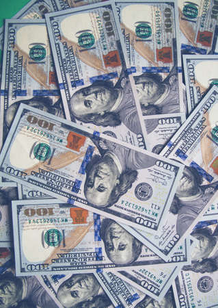 Chaotically spread out one hundred dollar bills. Background of chaotically scattered bills