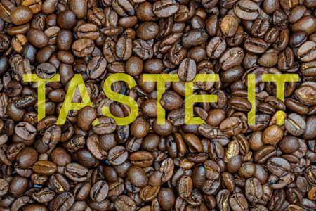 inscription coffee on the background of coffee beansの写真素材