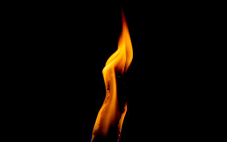 flame of a torch in the dark on a black background, only the fire is visibleの写真素材