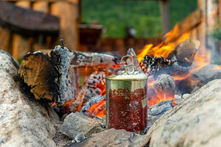 delicious canned food for lunch is cooked on a fire in the forestの写真素材
