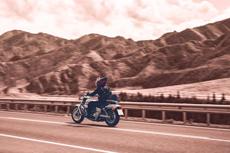 Man seat on the motorcycle on the mountain roadの写真素材