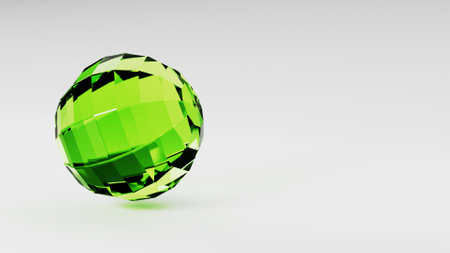 A green ball spins on a white surface like a liquid circle on paperweight glassの写真素材