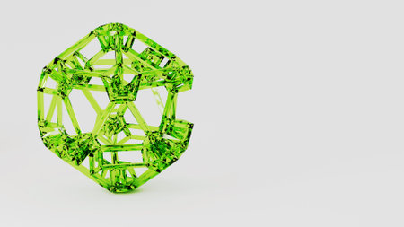 The green geometric object rests on a white surfaceの写真素材