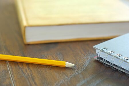 Pencil book notebook student study accesories. Education stationary closeup. Drawing pencil on desk home workplace.の写真素材