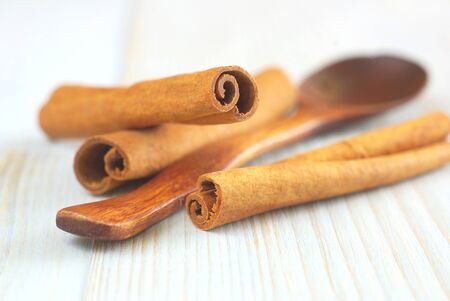 Cinnamon sticks with wooden spoon old style retro background. Selective focus.の写真素材