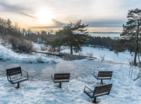 Observation deck with empty icy chairs. Winter day in the Ekeberg park.Ekeberg is a neighborhood in the city of Osloの写真素材