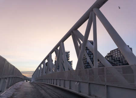 Pink sunset on a pedestrian bridge. Winter,An element of a modern pedestrian bridge. Deserted.の写真素材