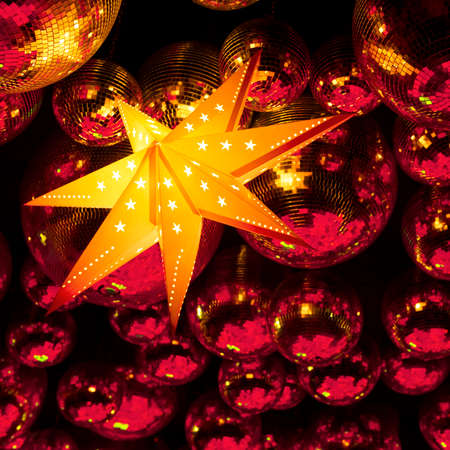 Nightclub red disco balls and gold glowing star in colorful party lights in dance club, nightlife entertainment industryの写真素材