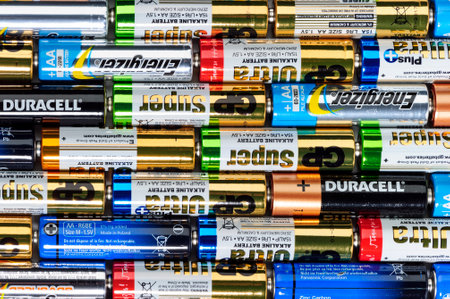 Moscow, Russia - January 05, 2016: Used alkaline batteries AA size format of different brands ready for recycling lying in a rows. Studio shot.のeditorial素材