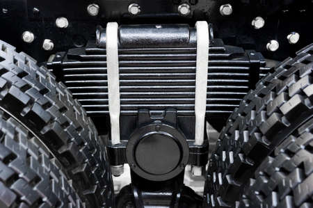 Leaf spring with four tires of commercial truck, black suspension with chrome nuts and bolts for oversize vehicles, SUV, cargo and construction mode of transports, heavy industry, detailの写真素材