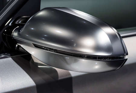Rear view mirror on side of concept modern sport racing silver carの写真素材