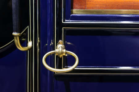 Car handle of vintage vehicle door, retro design, detail of old comfortable automobile with dark blue metallic bodywork, selective focusの写真素材
