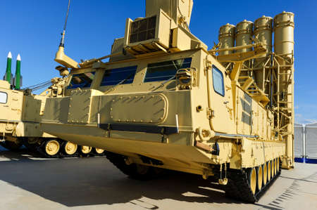 Antiaircraft missile complex, ballistic launcher with big four missiles ready to attack on military powerful all-terrain transportation with blue sky on background, modern army industryの写真素材