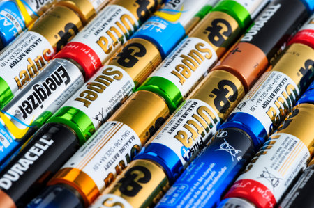 Moscow, Russia - January 05, 2016: Used alkaline batteries AA size format of different brands ready for recycling lying in a rows. Studio shot.のeditorial素材