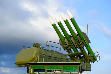 Missile launcher with four ballistic missiles ready to attack and radar on top of army transportation, antiaircraft forces, military industry, blue sky and clouds on backgroundの写真素材