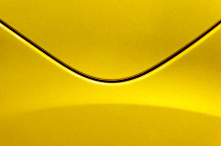 Smooth curves of bright yellow metal car body, abstract - steel post envelopeの写真素材
