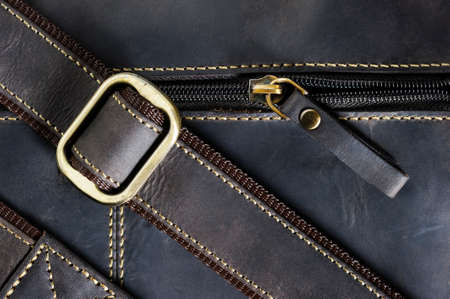 Leather bag with zipper, shoulder strap and stitches, men's accessories in vintage style, macro shot, selective focusの写真素材