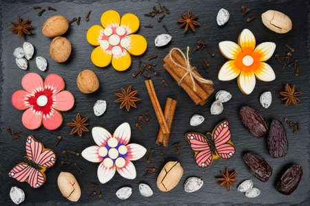 Gingerbread cookies with nuts, dates and spices, colorful homemade cakes in shape of flower and...