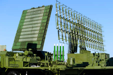 Air defense radars of military mobile antiaircraft systems in green color and ballistic rocket launcher with four cruise missiles in centre of frame, modern army industryの写真素材