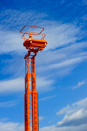 Hydraulic lift platform with bucket of orange construction vehicleの写真素材