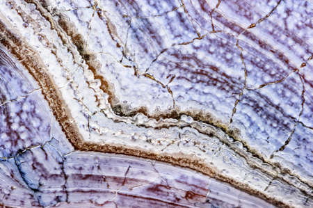 Agate stone texture with cracks, surface of natural unpolished mineral with striped pattern in blue...