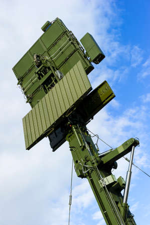 Air defense radar of military mobile antiaircraft system in green color, modern army industry, blue sky and white clouds on backgroundの写真素材